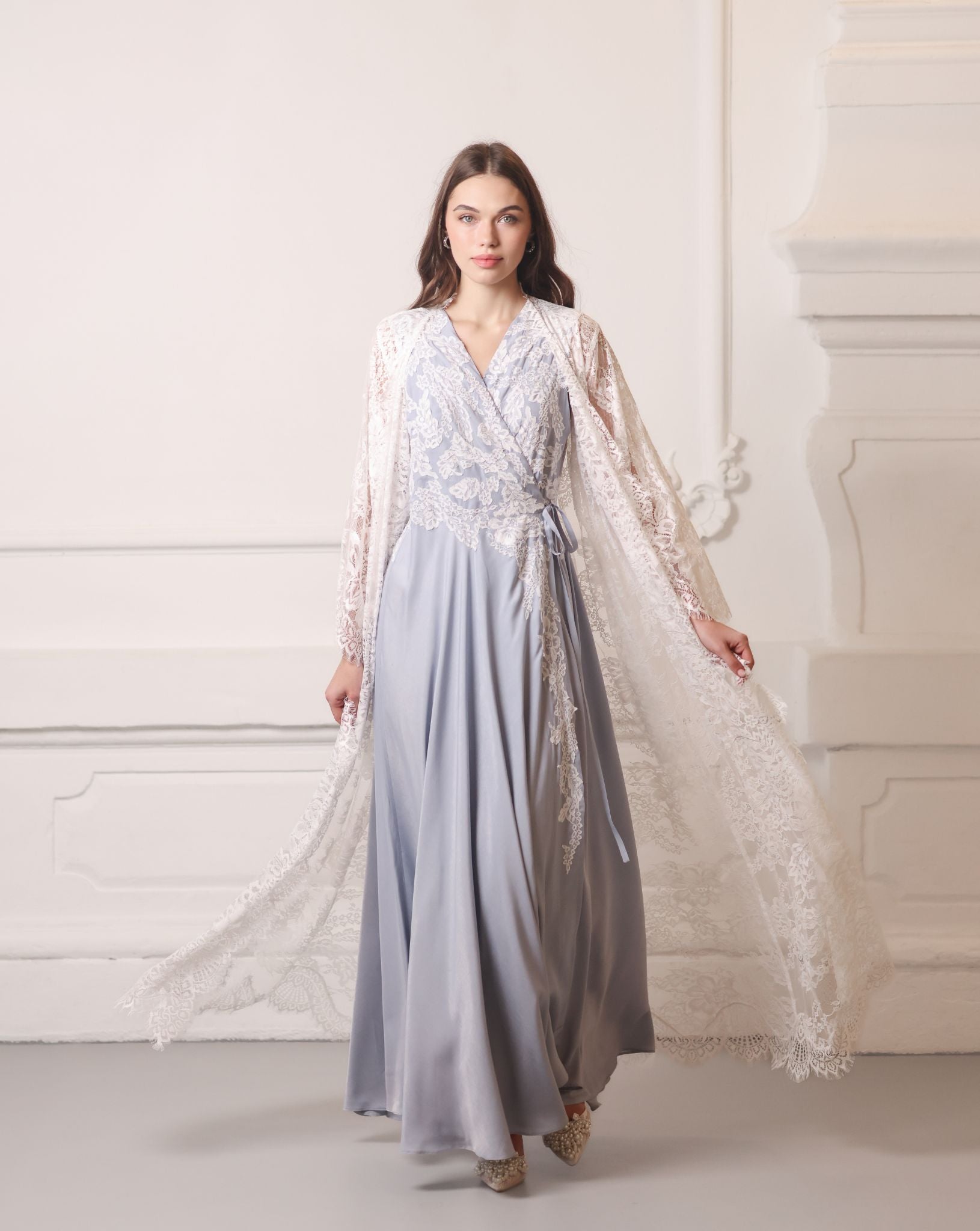 A dynamic walking shot with the sheer lace robe billowing softly behind, creating a romantic trailing effect.