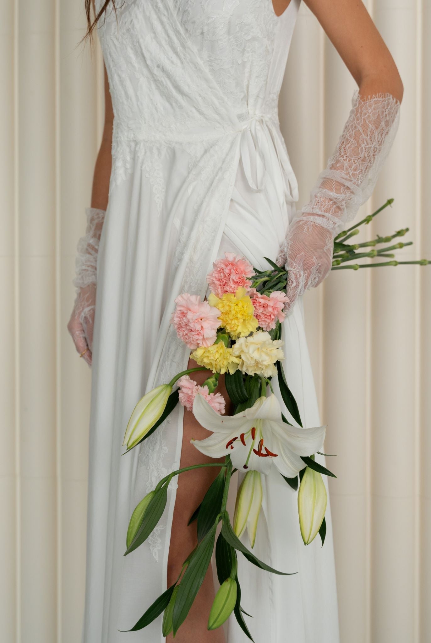 An artistic photograph of a woman wearing the nightwear while holding a delicate bouquet of flowers.