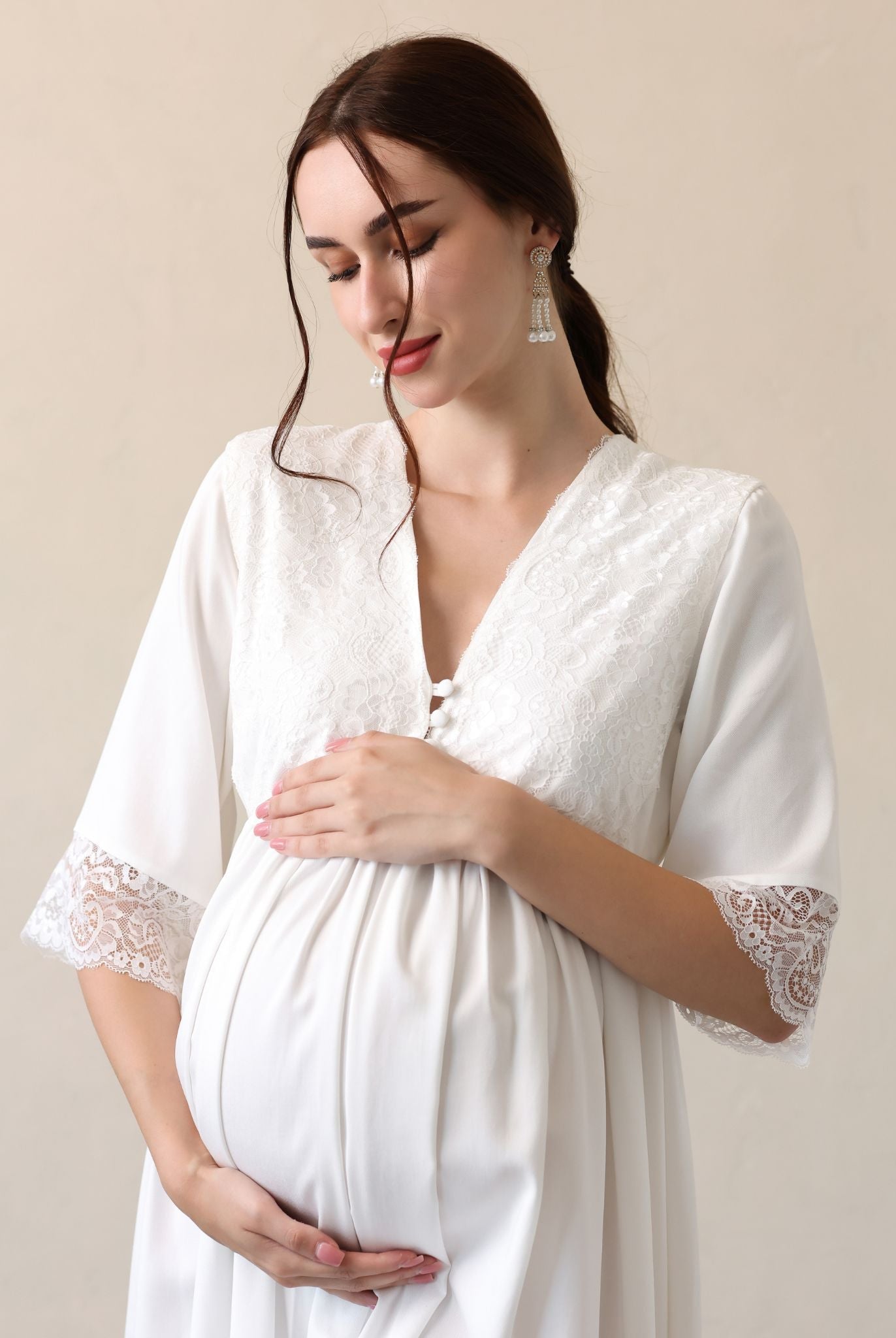 Mid-length shot focusing on the pregnancy bump and the gentle touch of the cotton-viscose blend on the skin.