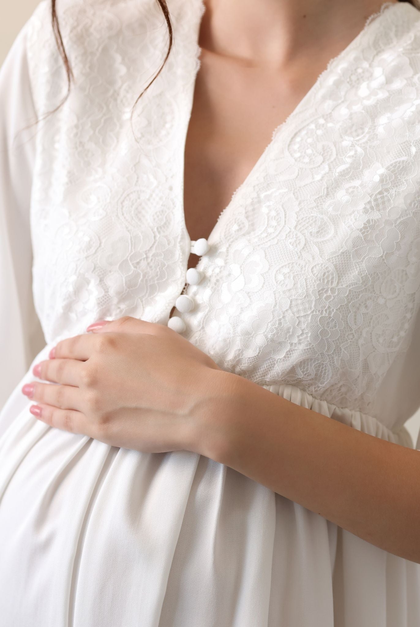View of the lace-trimmed neckline and front buttons, designed for quick and easy nursing access during pregnancy.