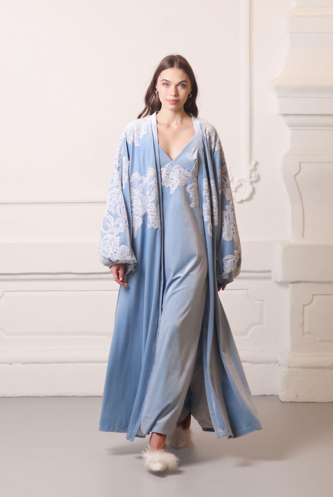 A flowing Velvet Robe and Nightgown Set in motion, showcasing the regal blue fabric and graceful silhouette.