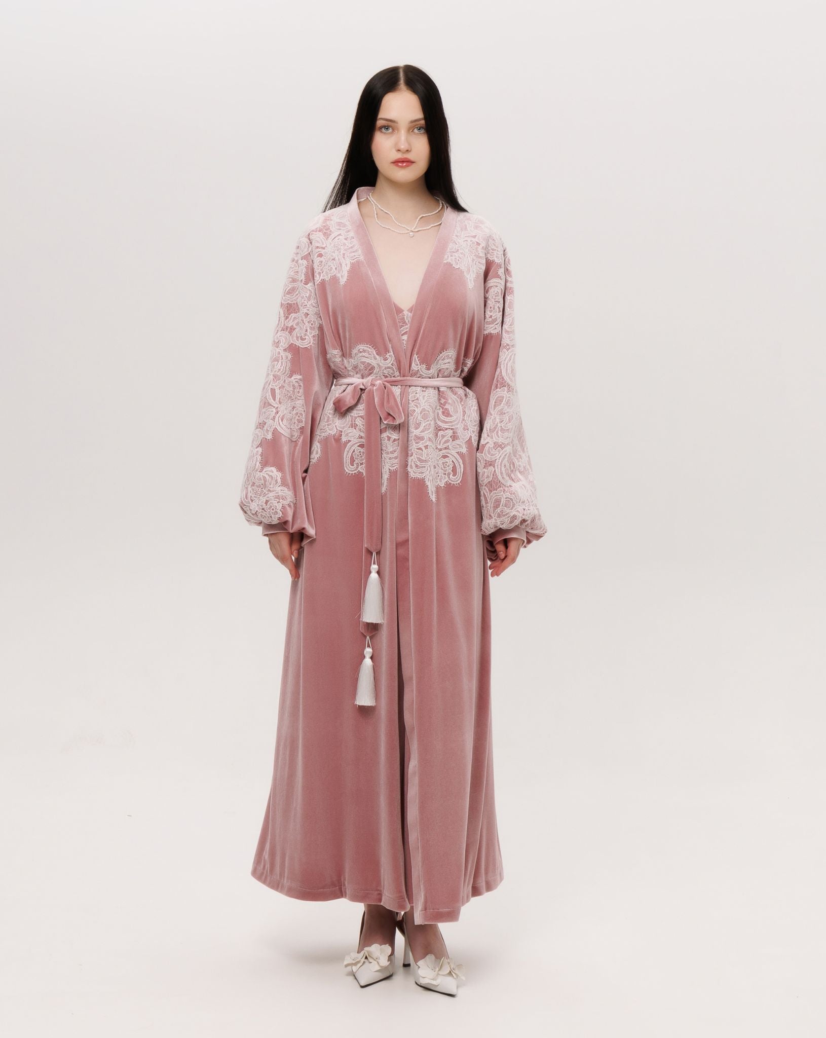The velvet robe shown in a wrap-over style with a tie, creating a warm and regal presence for lounging.