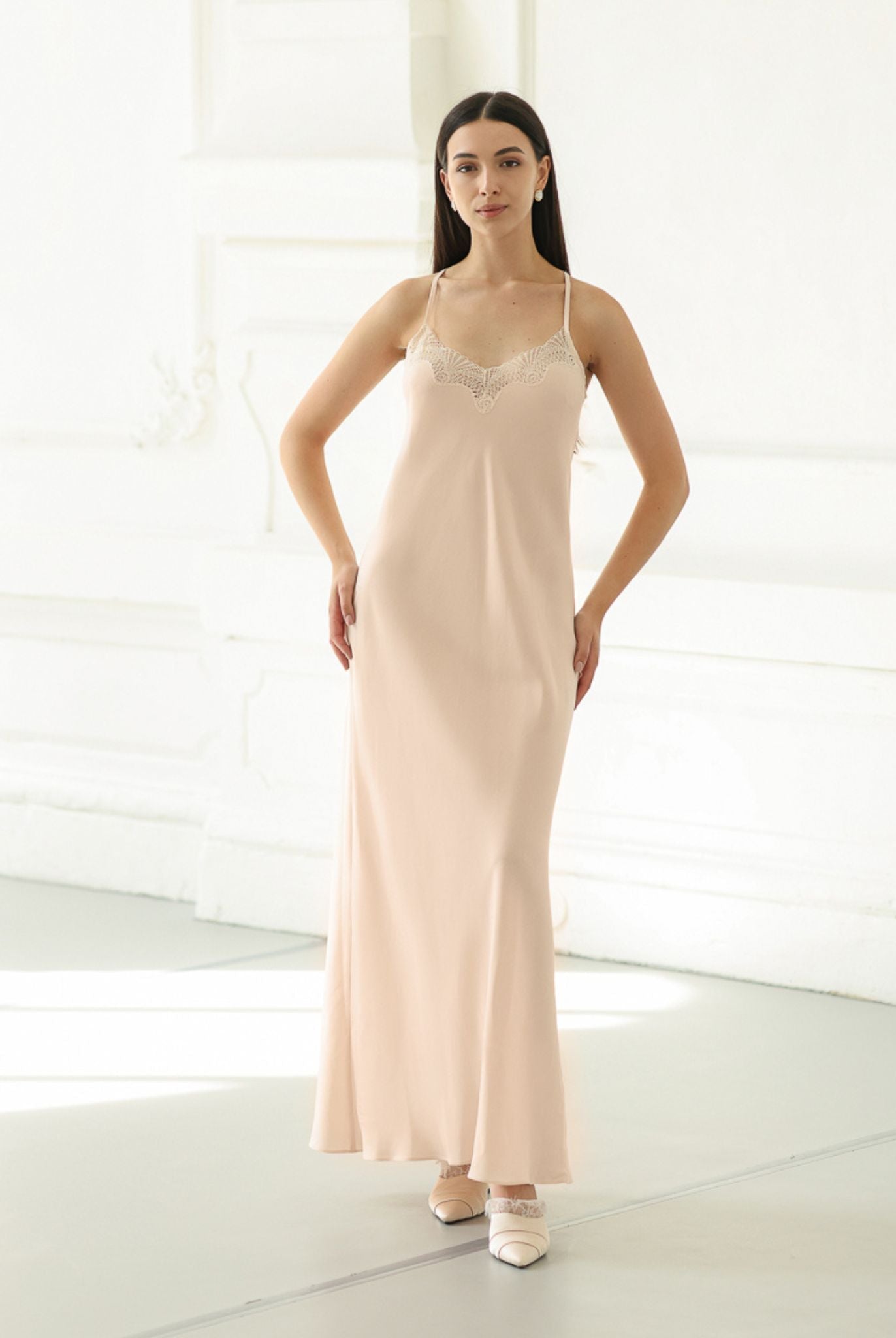 Standing in a lace-trimmed nightdress with hands on the hips, highlighting the soft texture and comfortable fit.