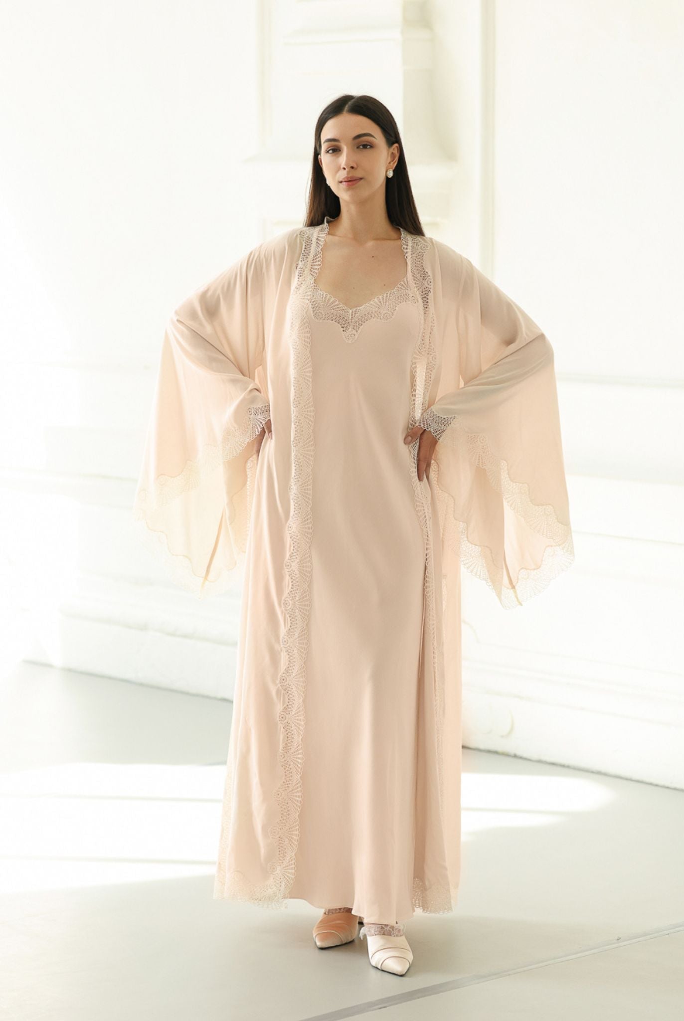 A Cotton Robe and Nightgown Set with hands on the waist, showcasing the wide sleeves and delicate lace detailing.
