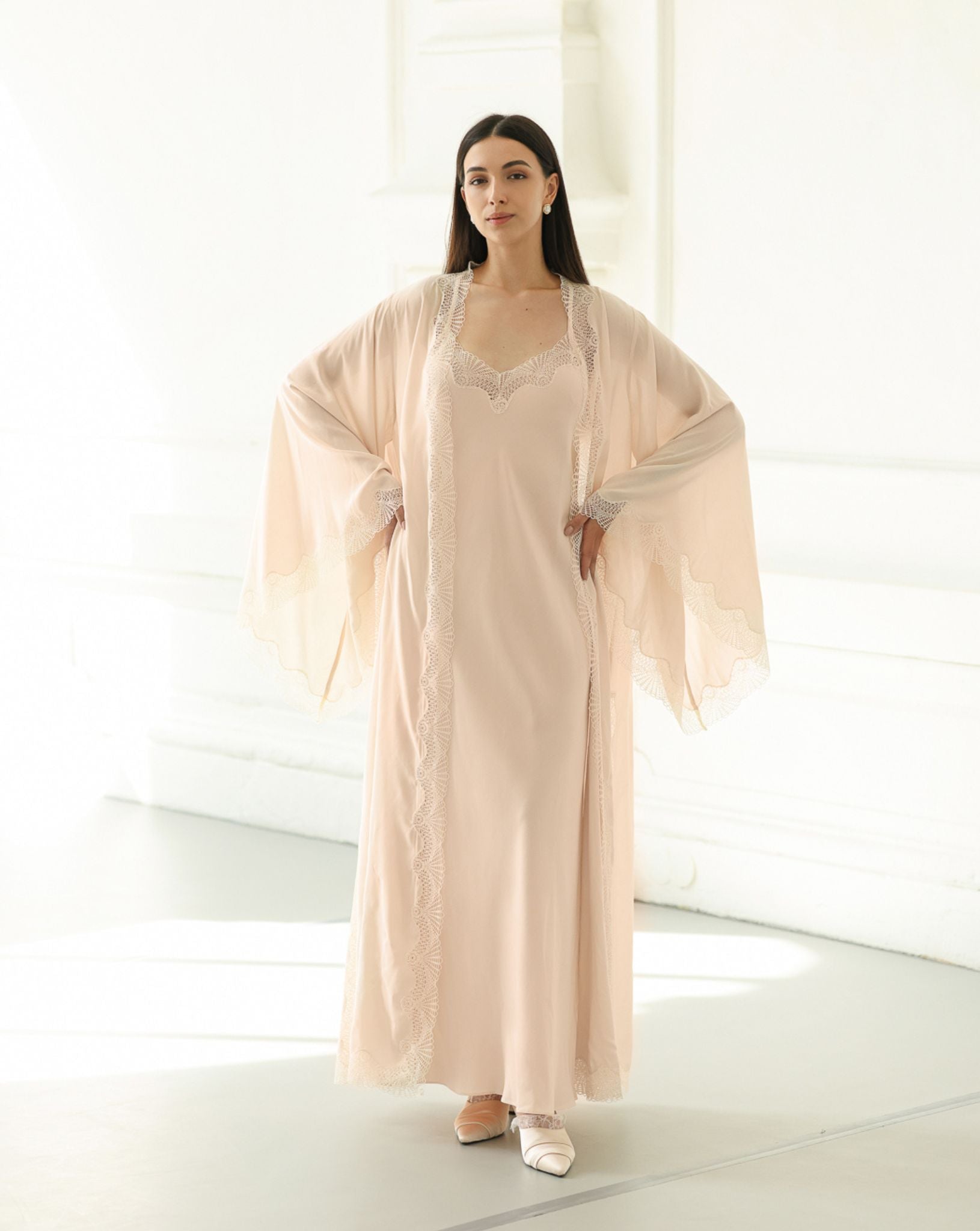 A Cotton Robe and Nightgown Set with hands on the waist, showcasing the wide sleeves and delicate lace detailing.