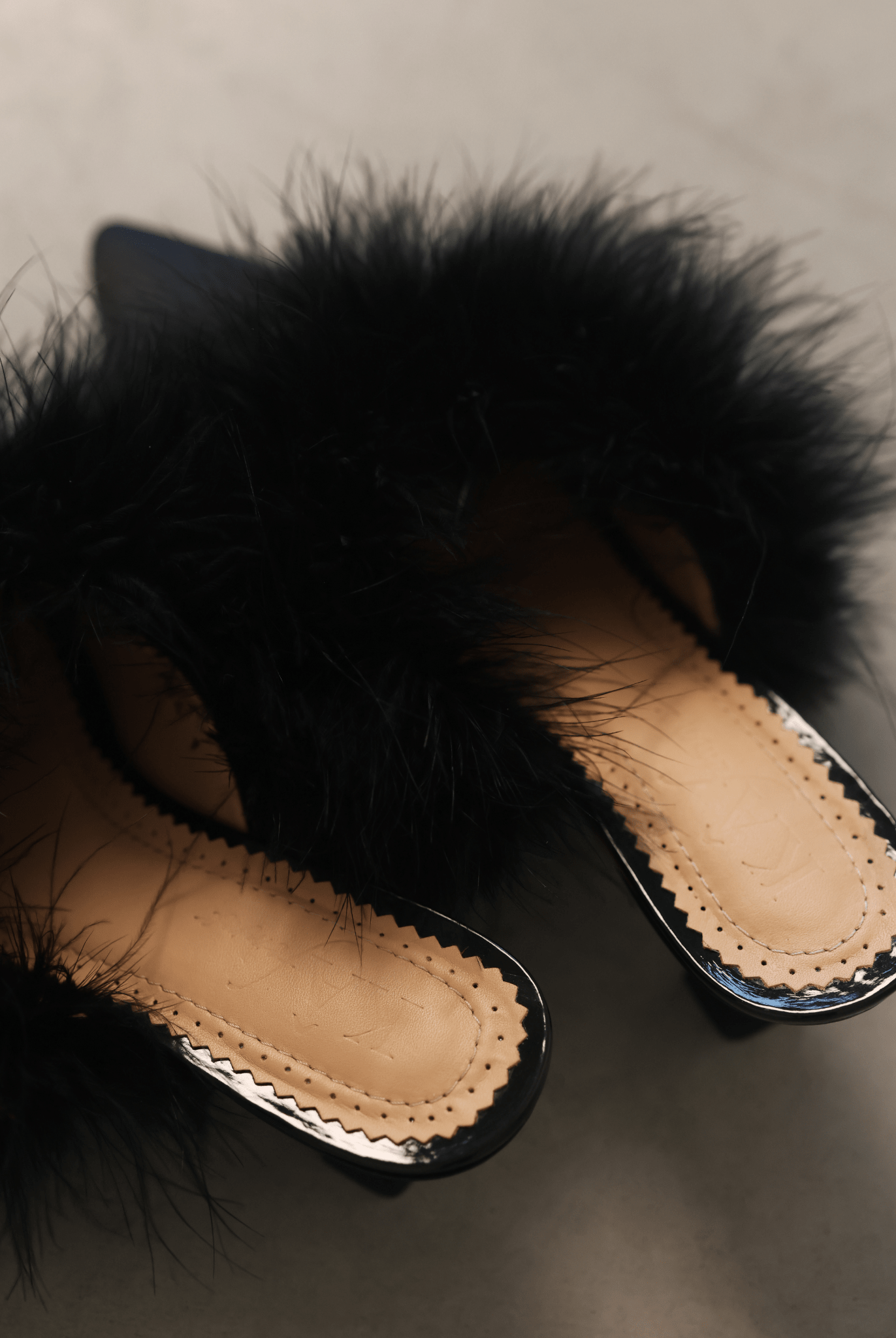 A rear view of the Satin Slippers, highlighting the 5 cm heel and how the soft feathers sway beautifully.