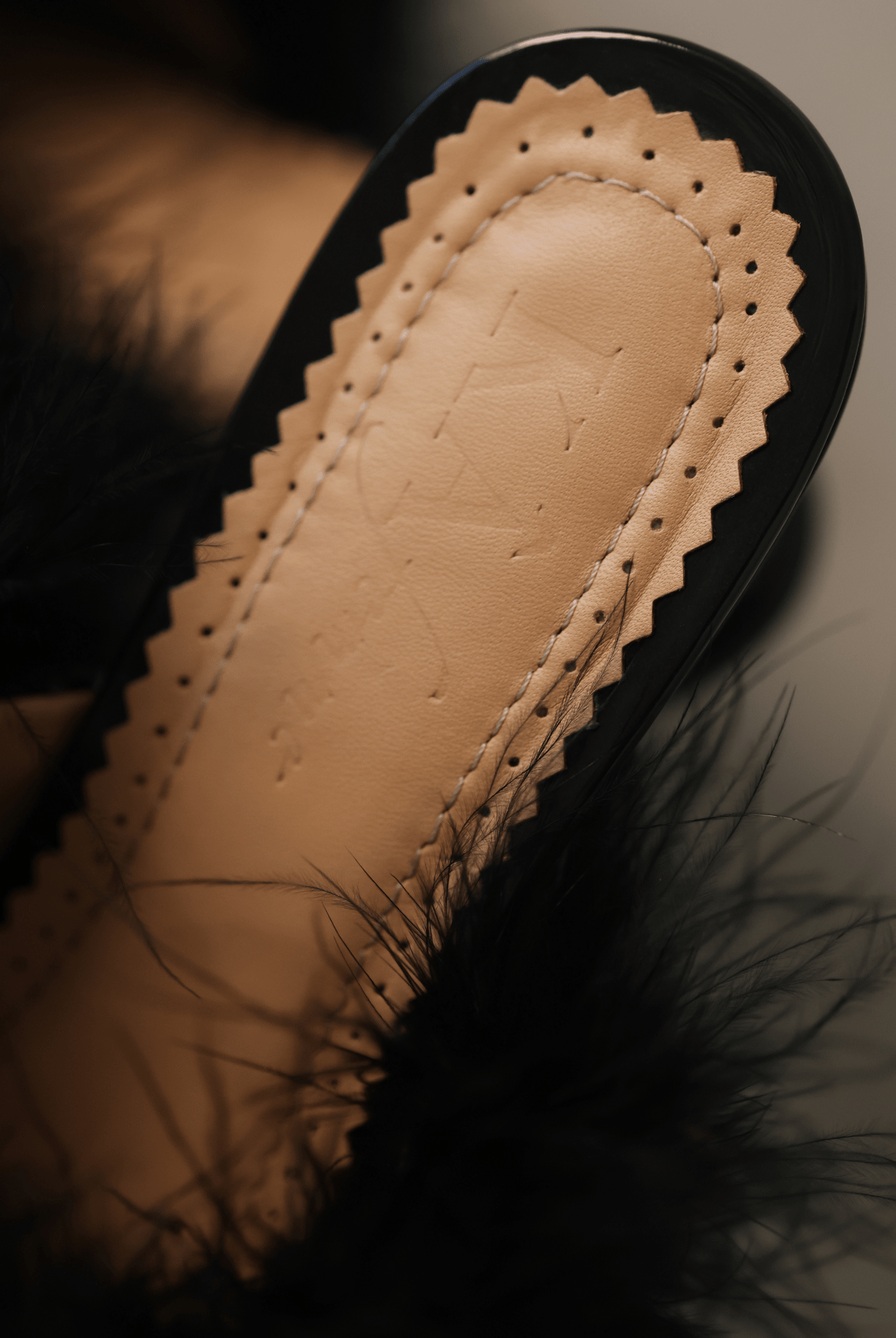 A detailed shot of the genuine leather insole, showcasing the brand's logo and soft padding for comfort.