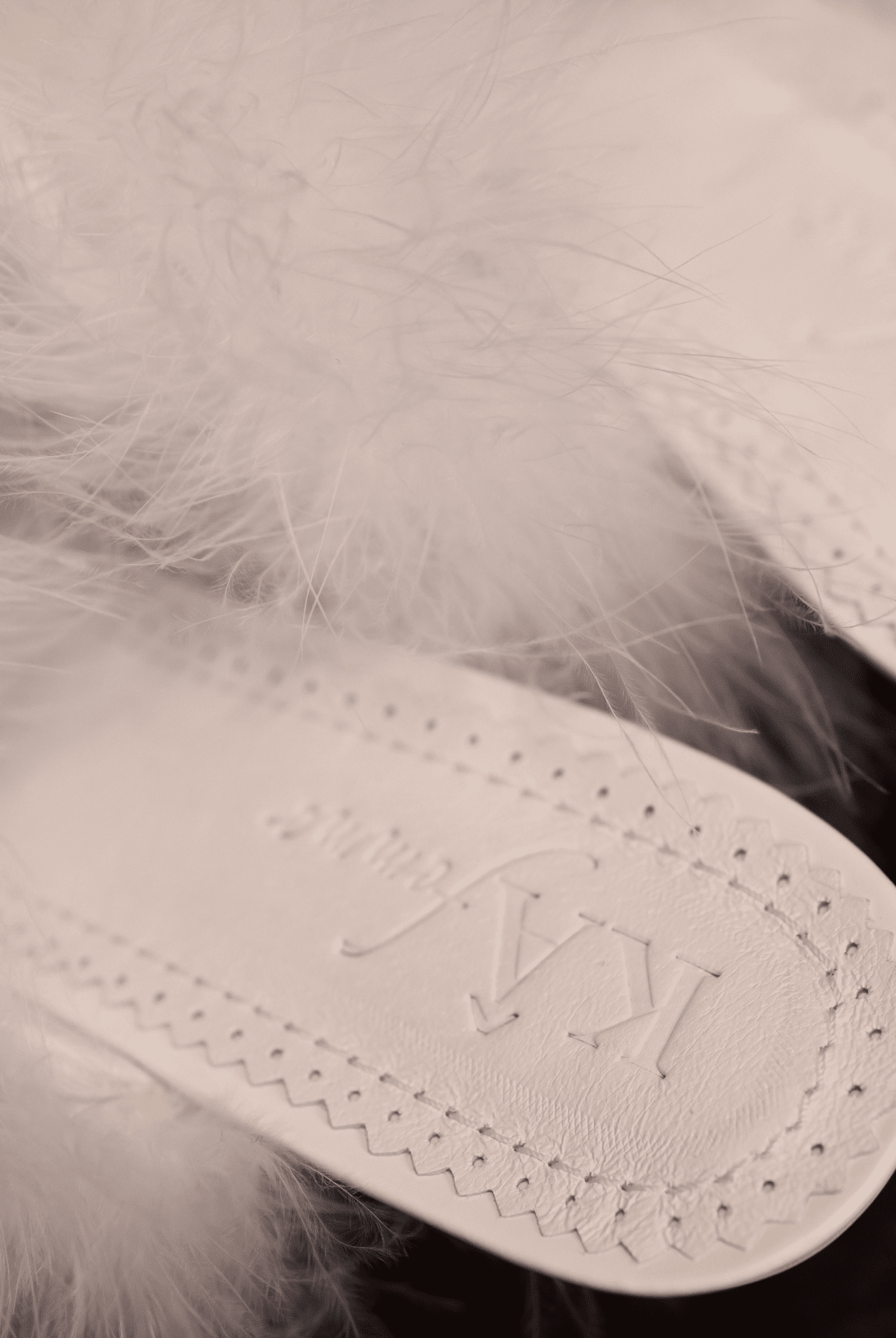 Close-up of the genuine leather insole featuring the brand engraving and soft padding for cloud-like comfort.