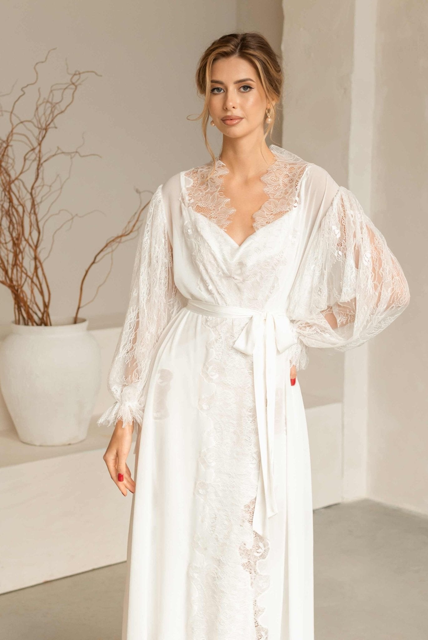 Medium shot focusing on the intricate lace details and elegant drape of the Peony bridal robe and nightgown.