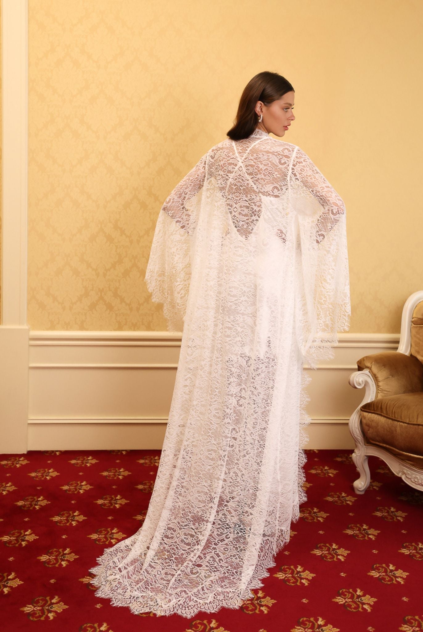 Rear view of the lace robe emphasizing the elegant long train and the intricate patterns of premium French lace.