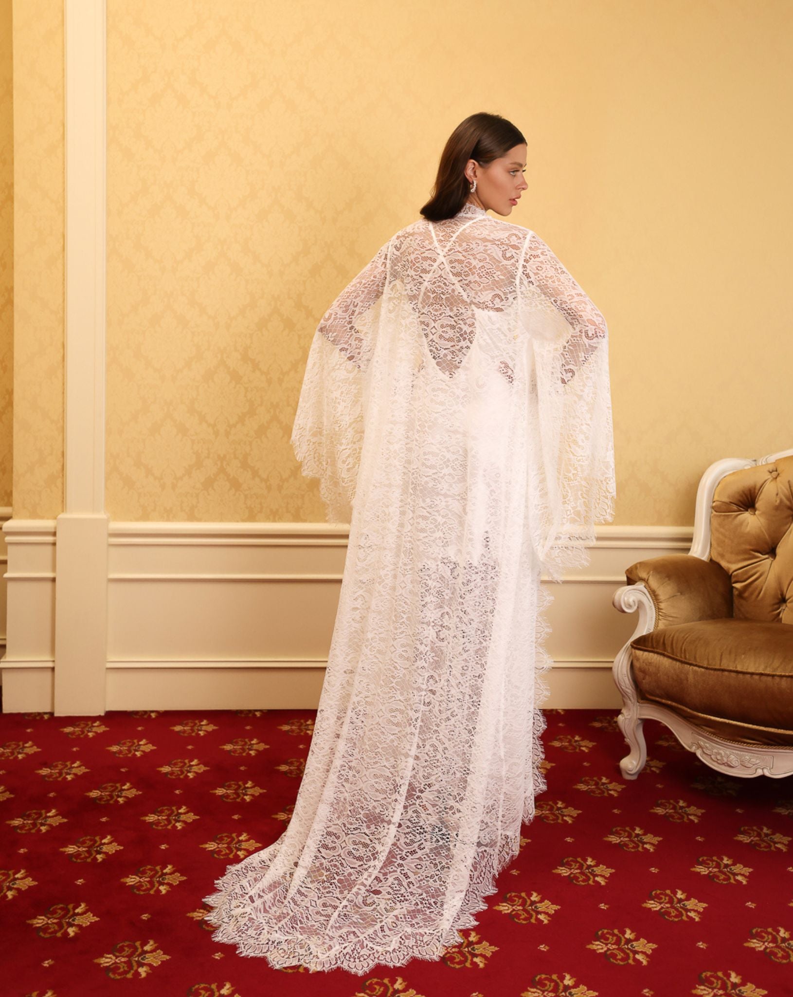 Rear view of the lace robe emphasizing the elegant long train and the intricate patterns of premium French lace.