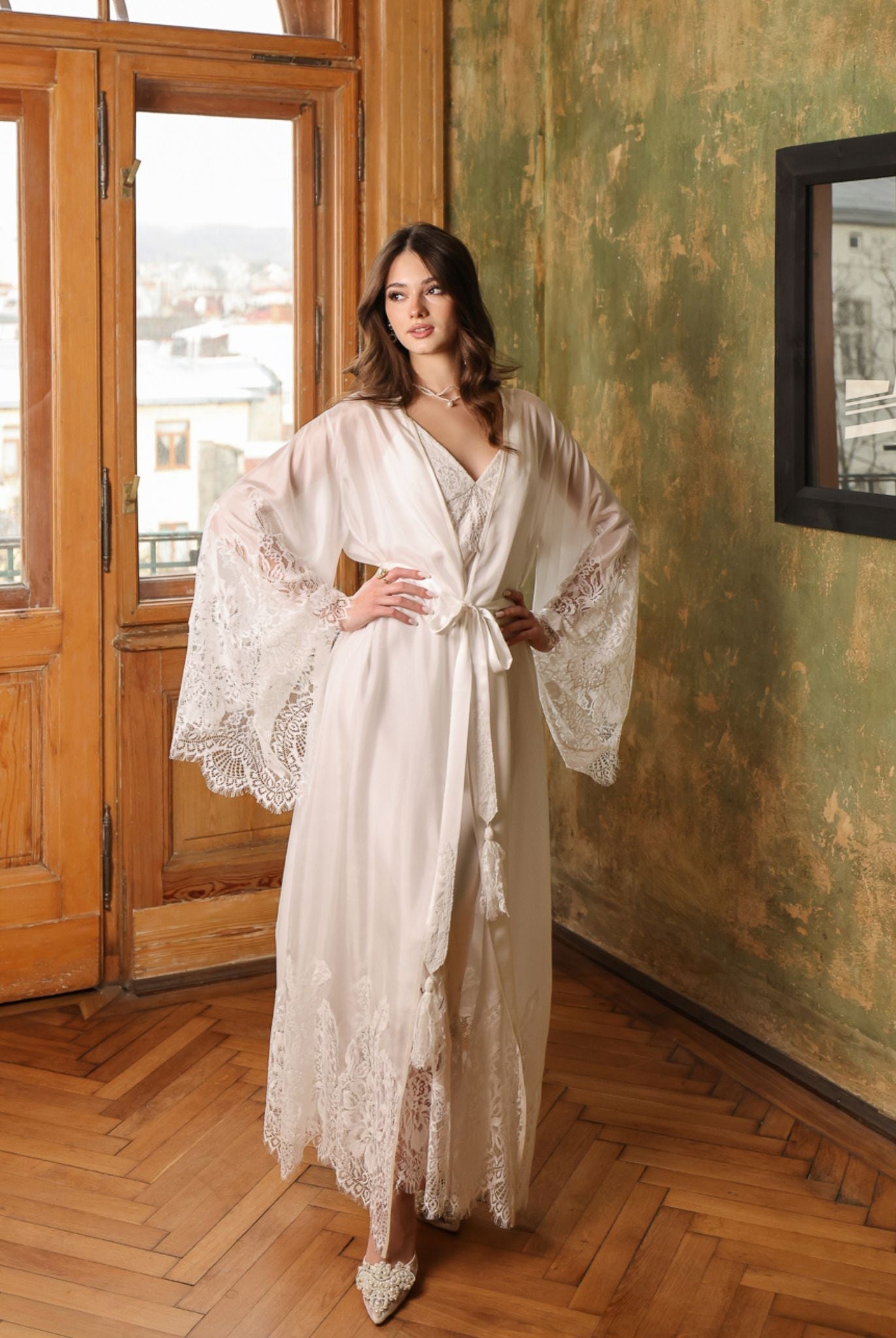 White bridal ensemble in a full-length view with hands on the waist, showcasing the fluid fall of mulberry silk.