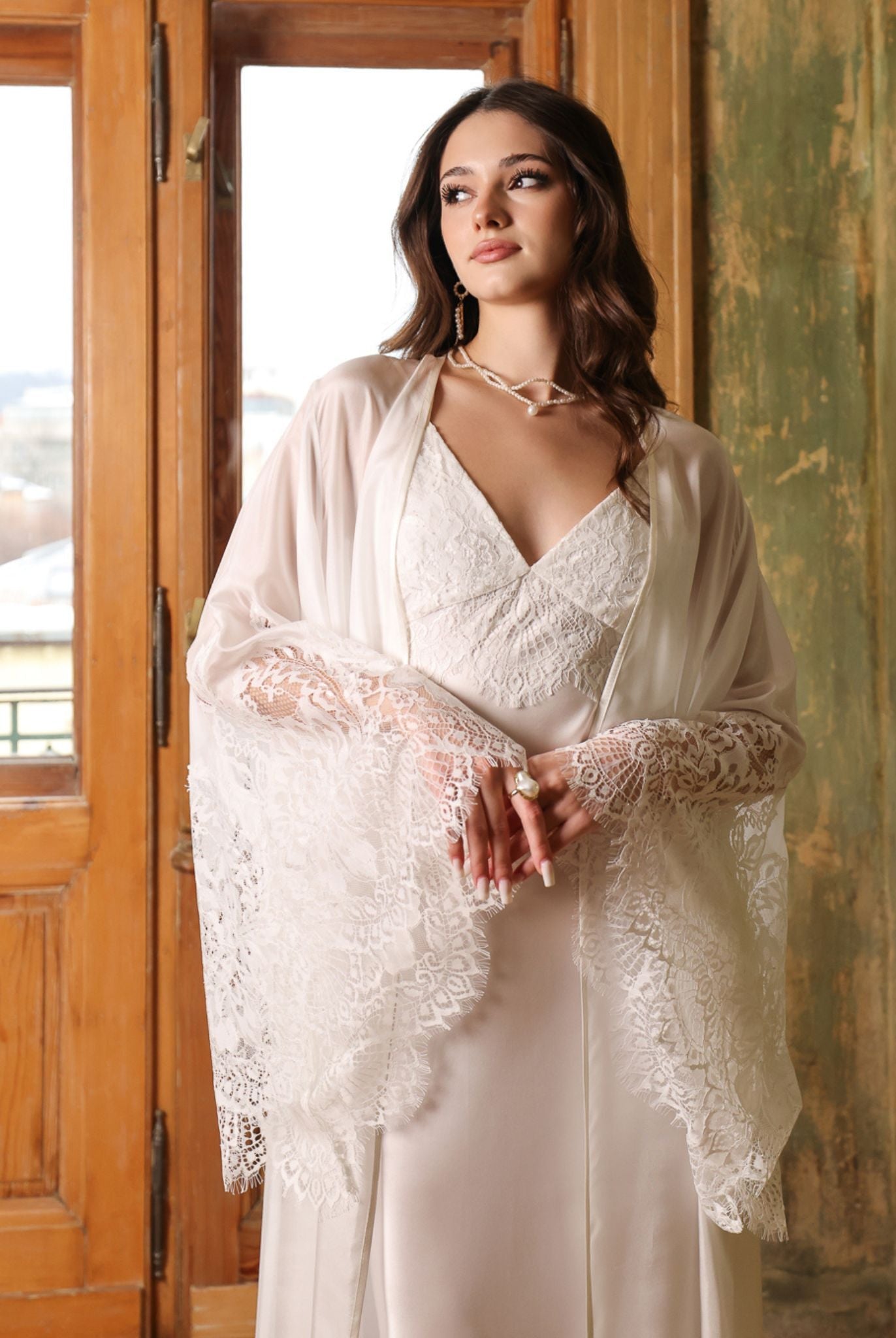 Half-body shot of the bridal silk wrap layered over a satin gown, highlighting the refined textures of the set.