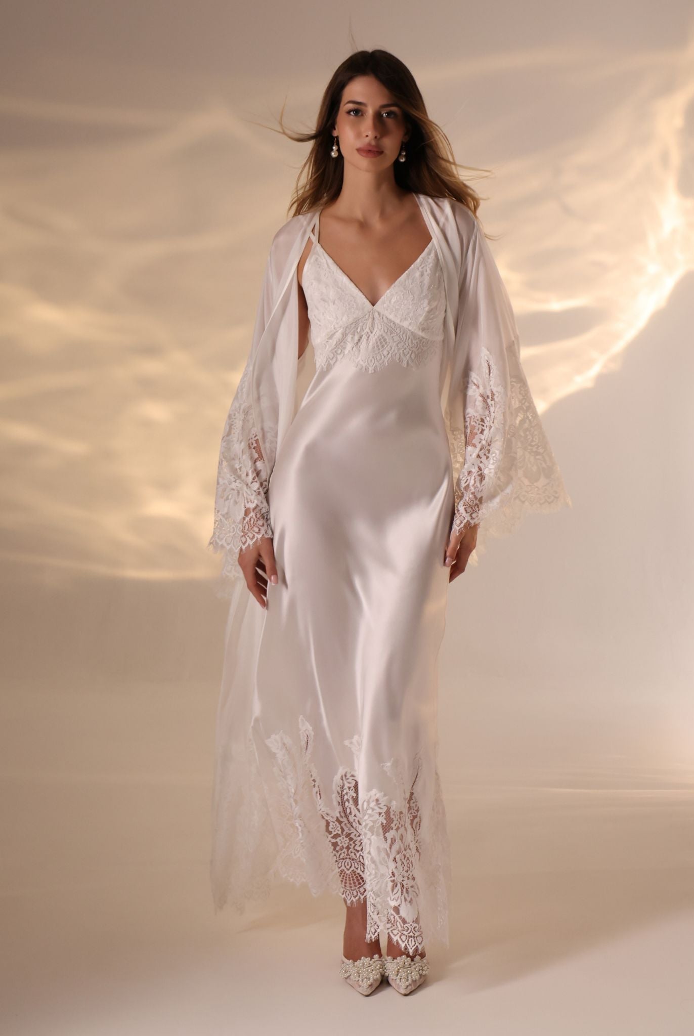 A full-length shot of a woman with her hair and robe flowing beautifully, creating a sense of graceful movement.