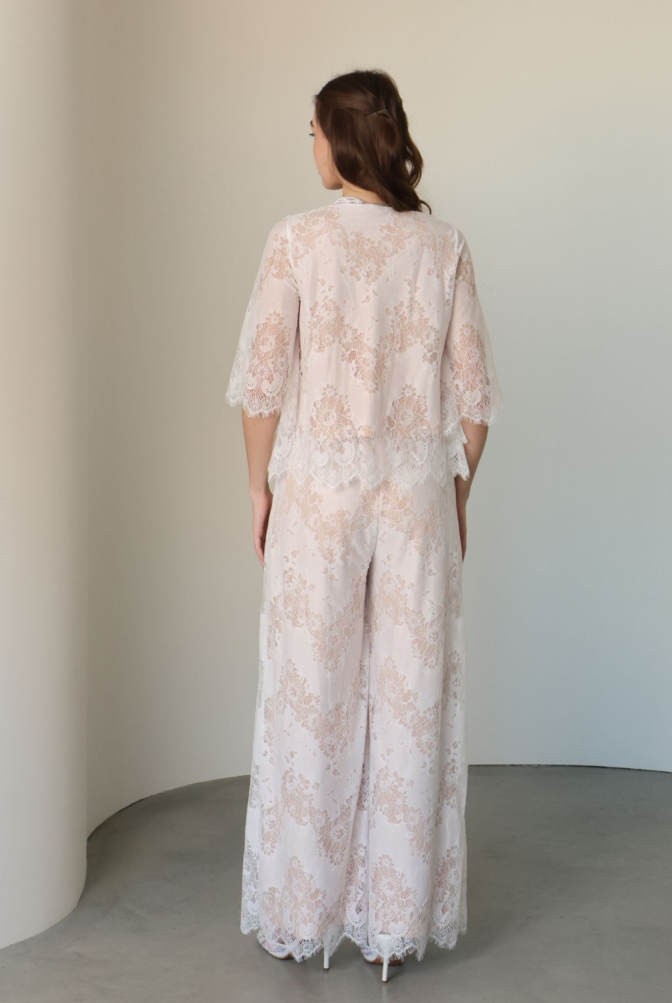 Rear view of the set, showcasing the wide lace-trimmed trousers and the airy, romantic design.