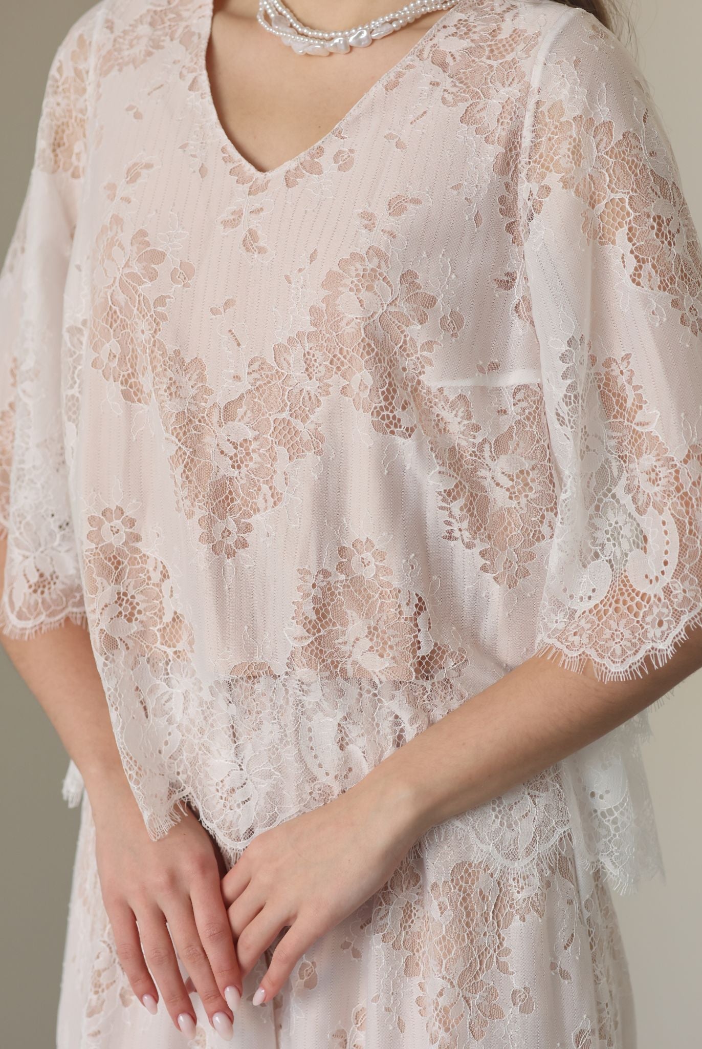 A detailed shot of the flowing top, focusing on the subtle floral patterns and breathable cotton lining.