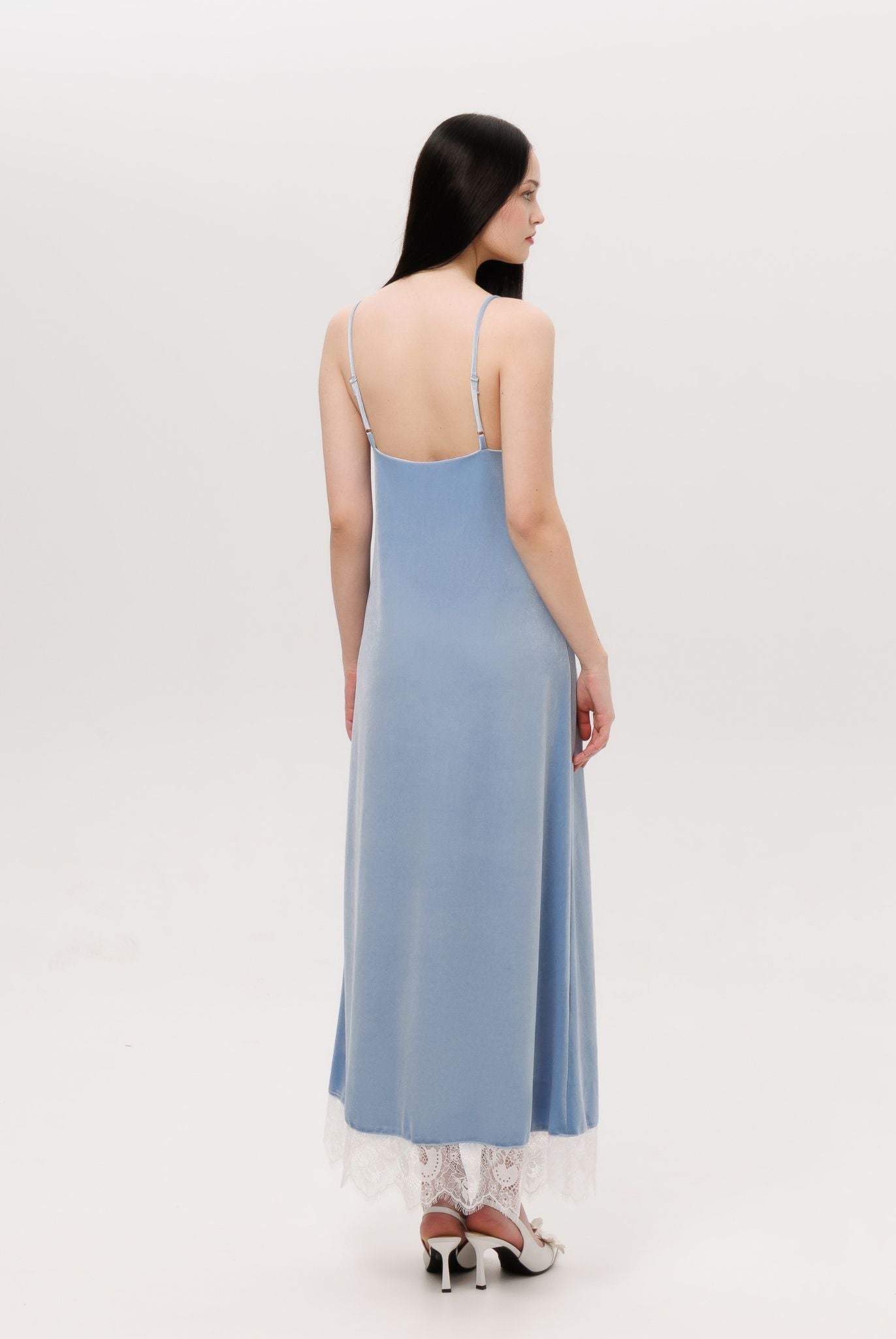 Rear view of the nightgown, highlighting the smooth drape of the velvet and the elegant length regulation.