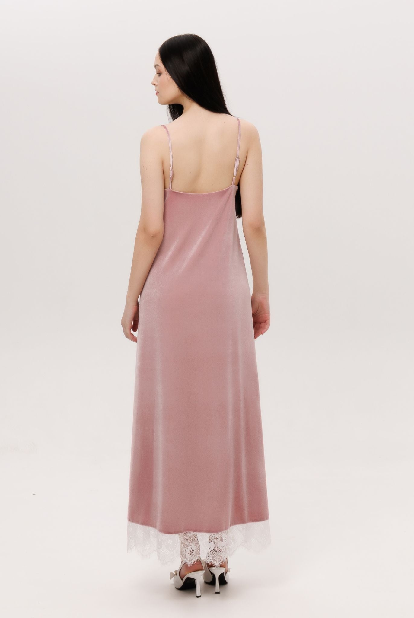 Back perspective of the long velvet gown, showing how the material follows the figure with ease and warmth.