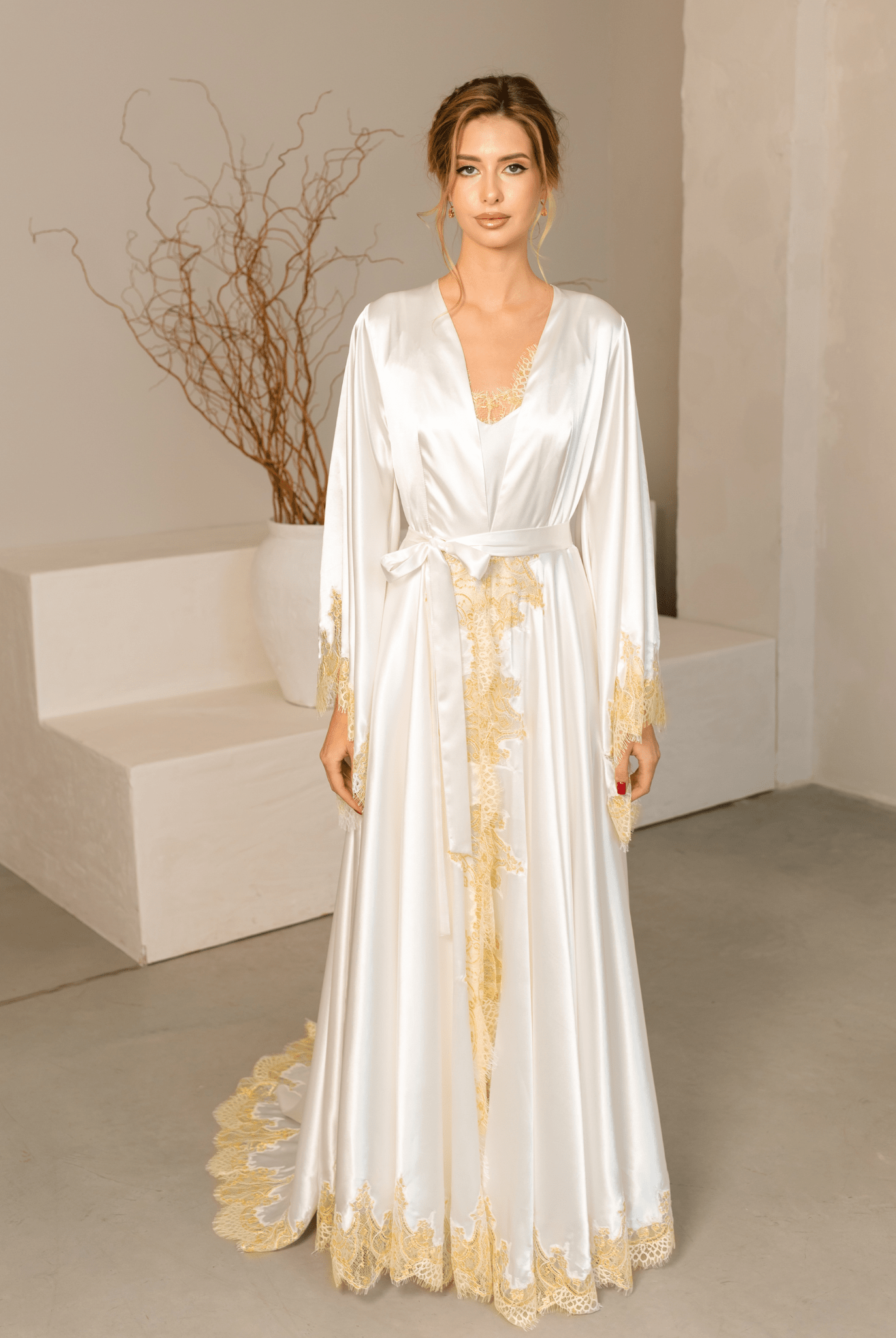 Full-length front view of the satin robe with lace accents, tied at the waist with a long flowing train.