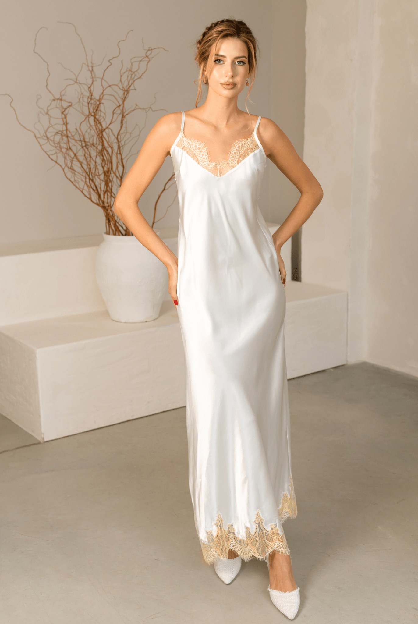 Elegant white Bridal Nightgown in delicate floral lace with wide butterfly sleeves and a long flowing skirt.