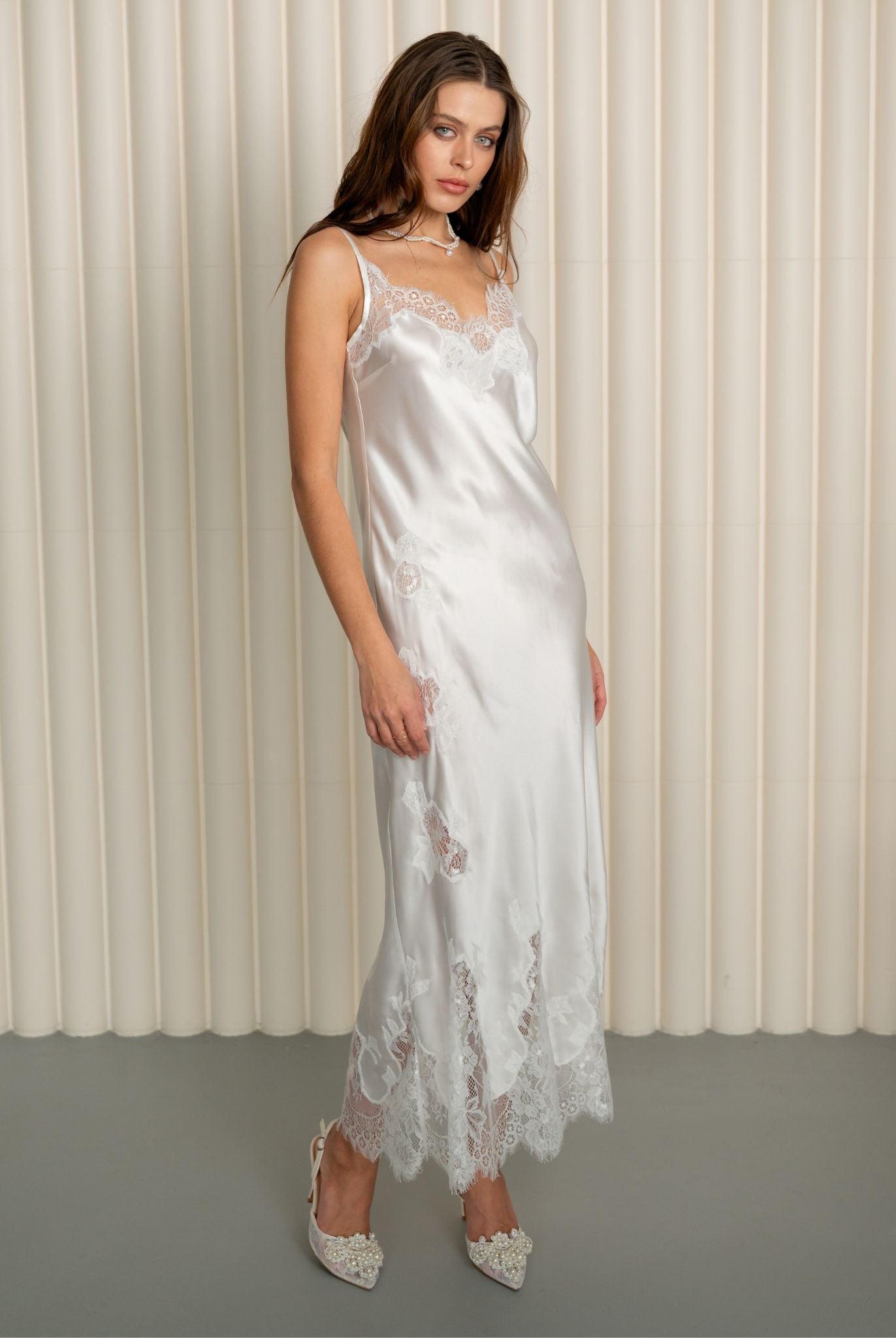 Model in white silk nightgown with lace details by Kafemme