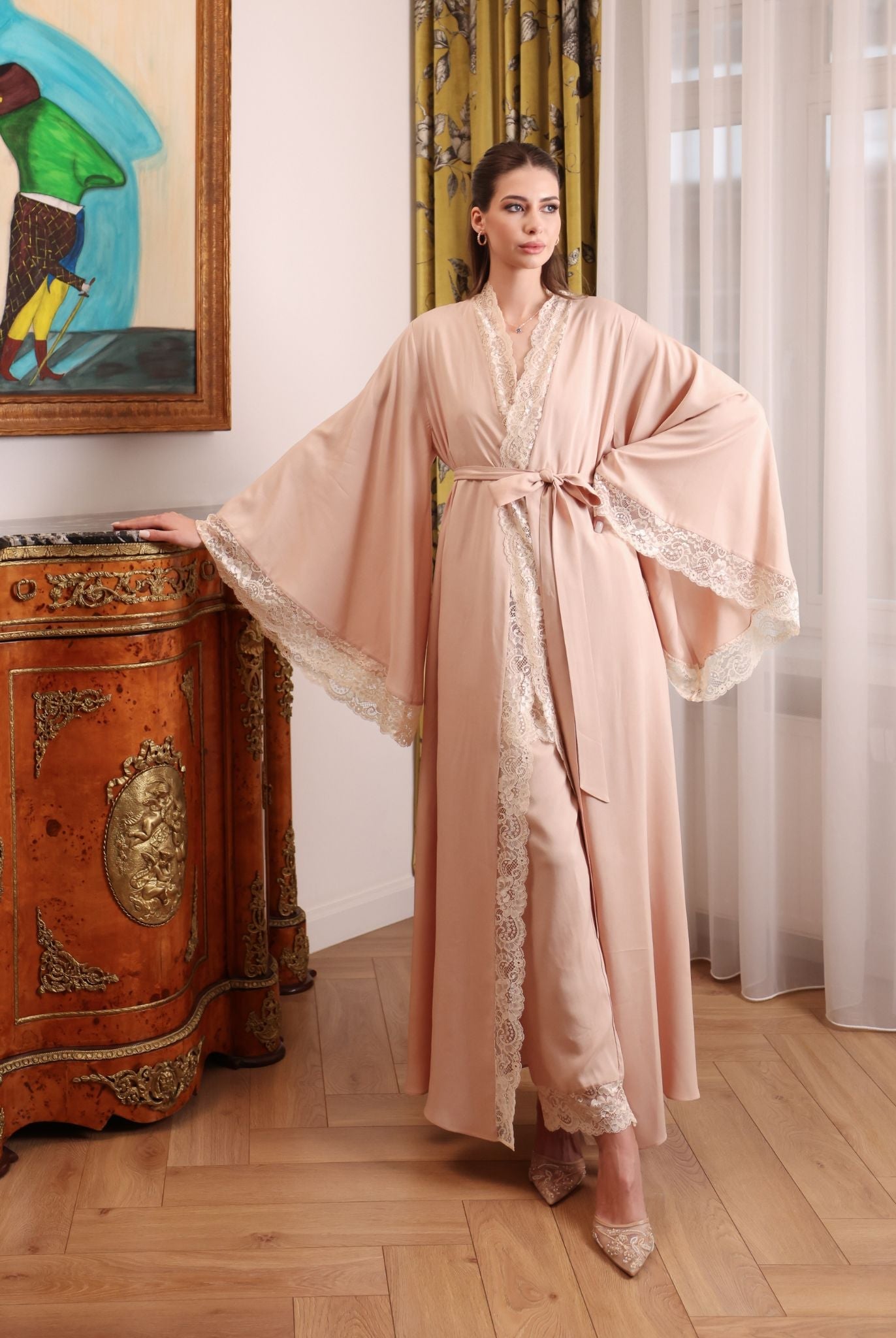 A poised shot focusing on the wide, flared sleeves of the robe, highlighted by refined lace for a touch of grace.