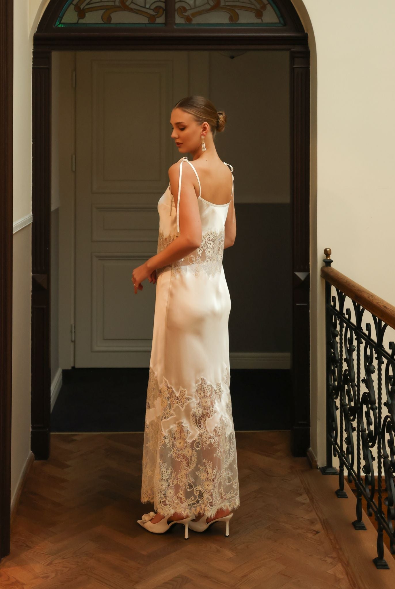 Rear view of the silk nightgown, showcasing the delicate shoulder strap ties and the sensual, soft satin texture.