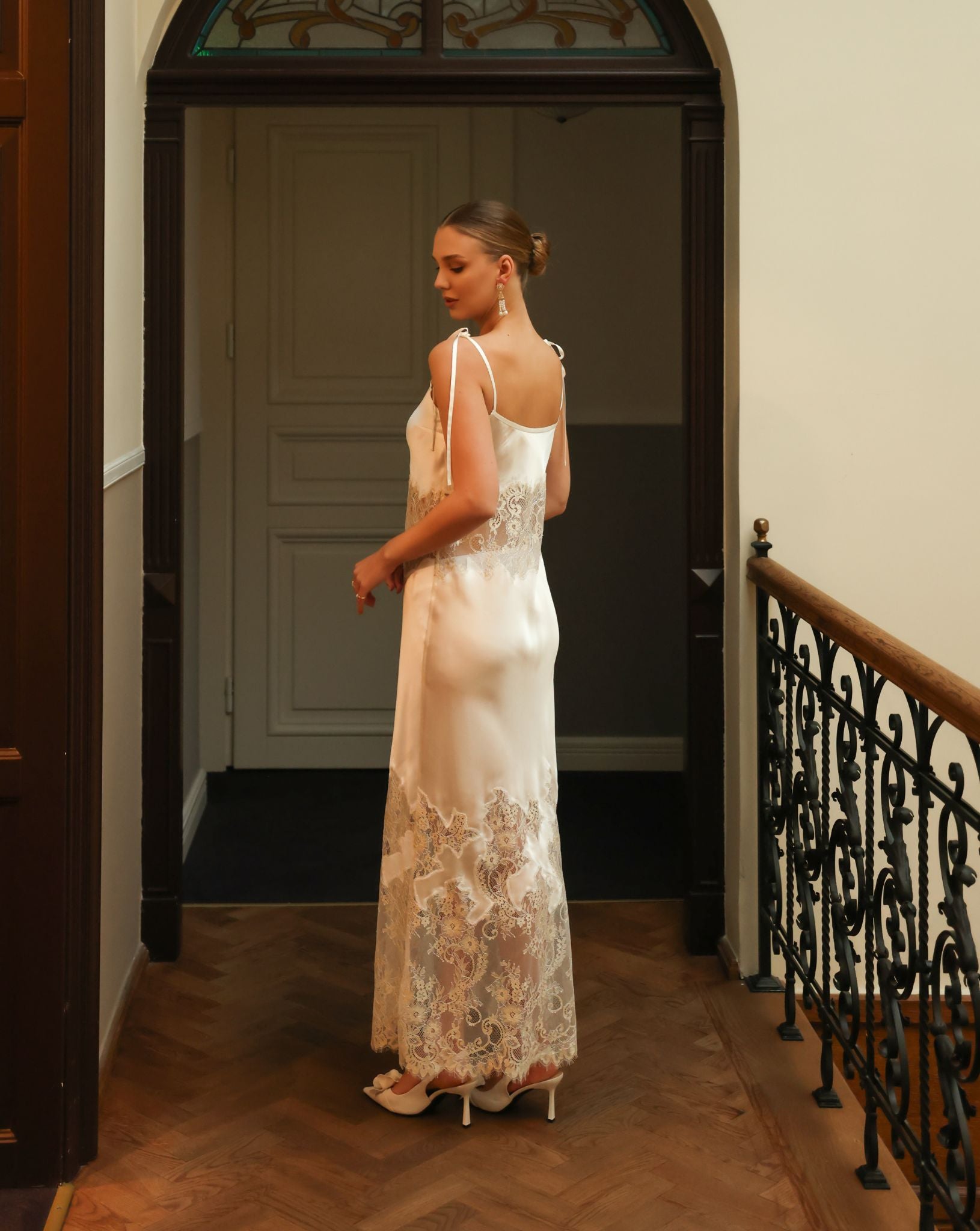 Rear view of the silk nightgown, showcasing the delicate shoulder strap ties and the sensual, soft satin texture.