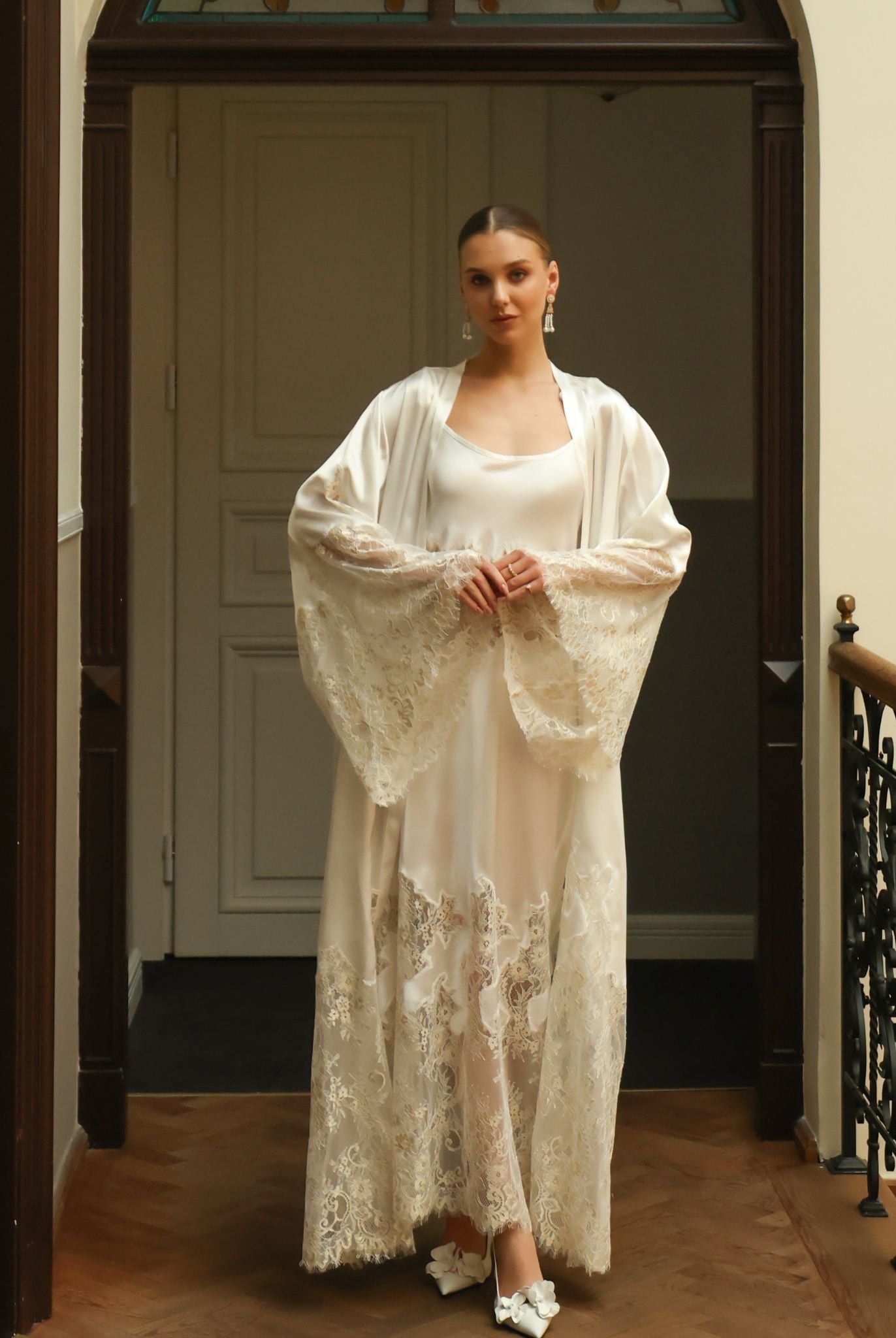 Standing full-length pose focusing on the wide sleeves adorned with exquisite lace inserts for a refined look.