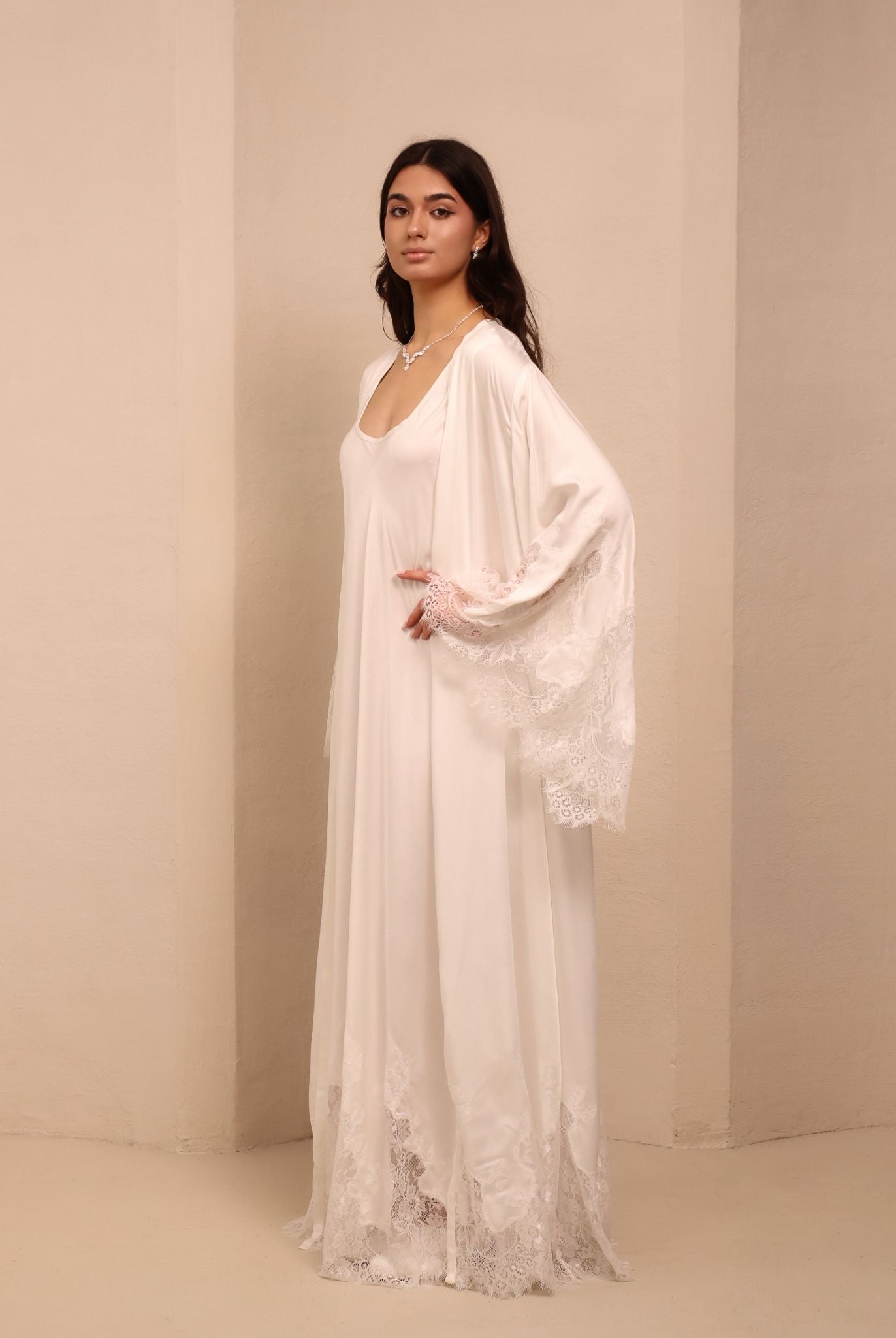 Side view of the white ensemble, highlighting the coordinating robe adorned with delicate lace trim on the sleeves.