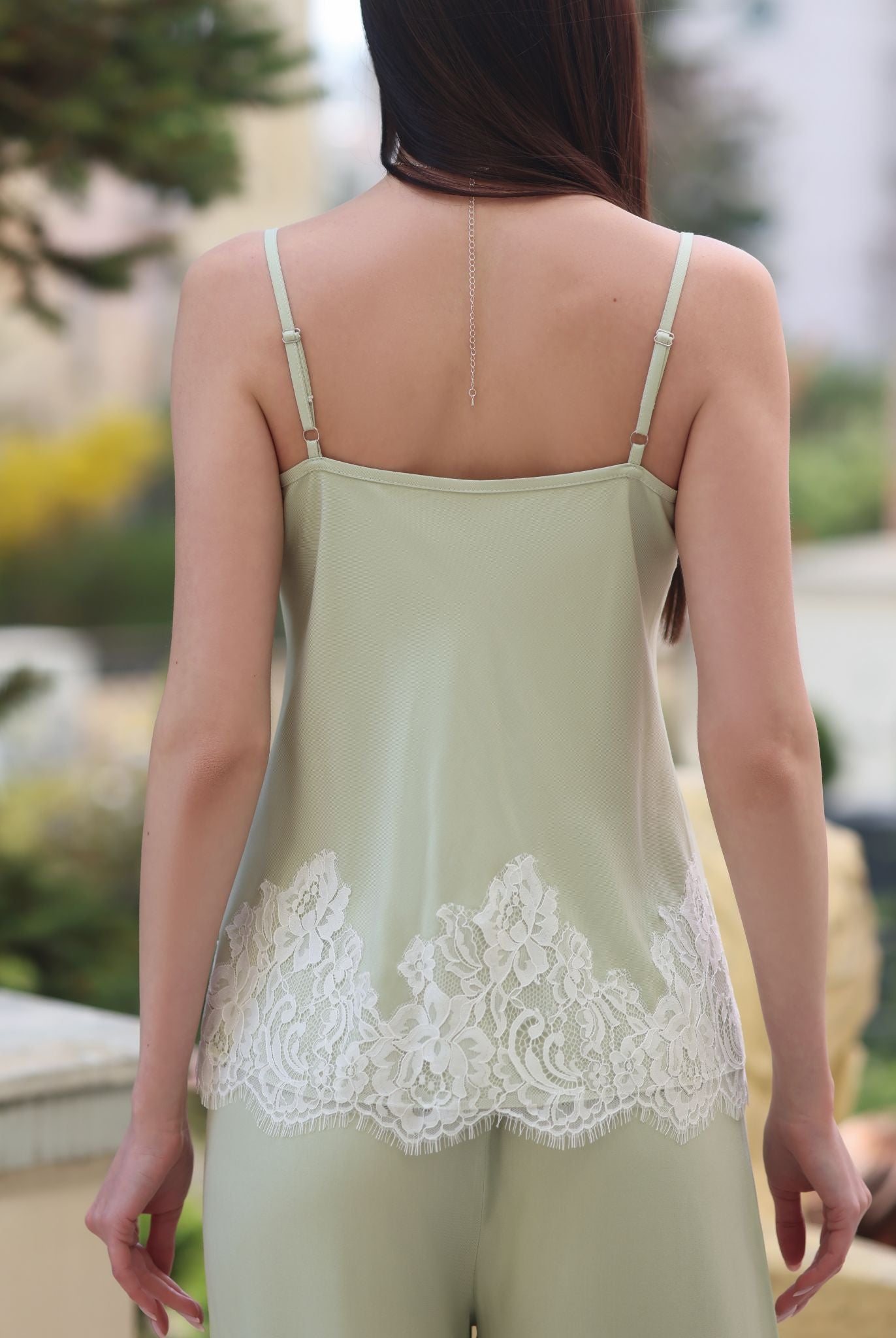 A close-up of the tank top from behind, focusing on the adjustable straps and the smooth texture of the fabric.
