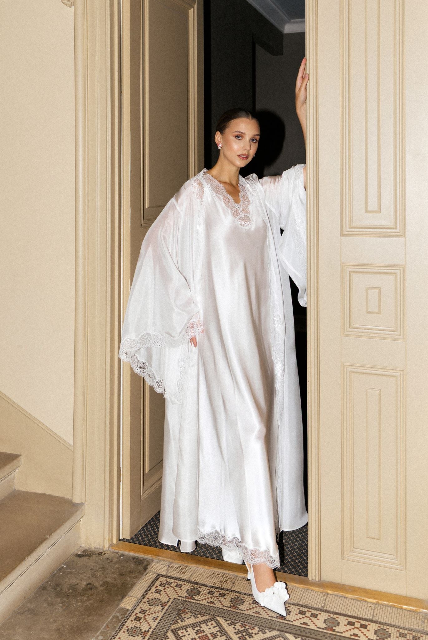 White Silk Robe and Nightgown Set shown by the doors in a full-length view, highlighting its modest and refined luxury.