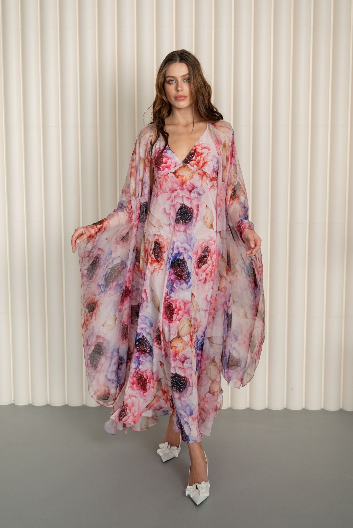 Full-length shot of a walking woman, featuring the airy movement of a floor-length sheer silk wrap-over robe.