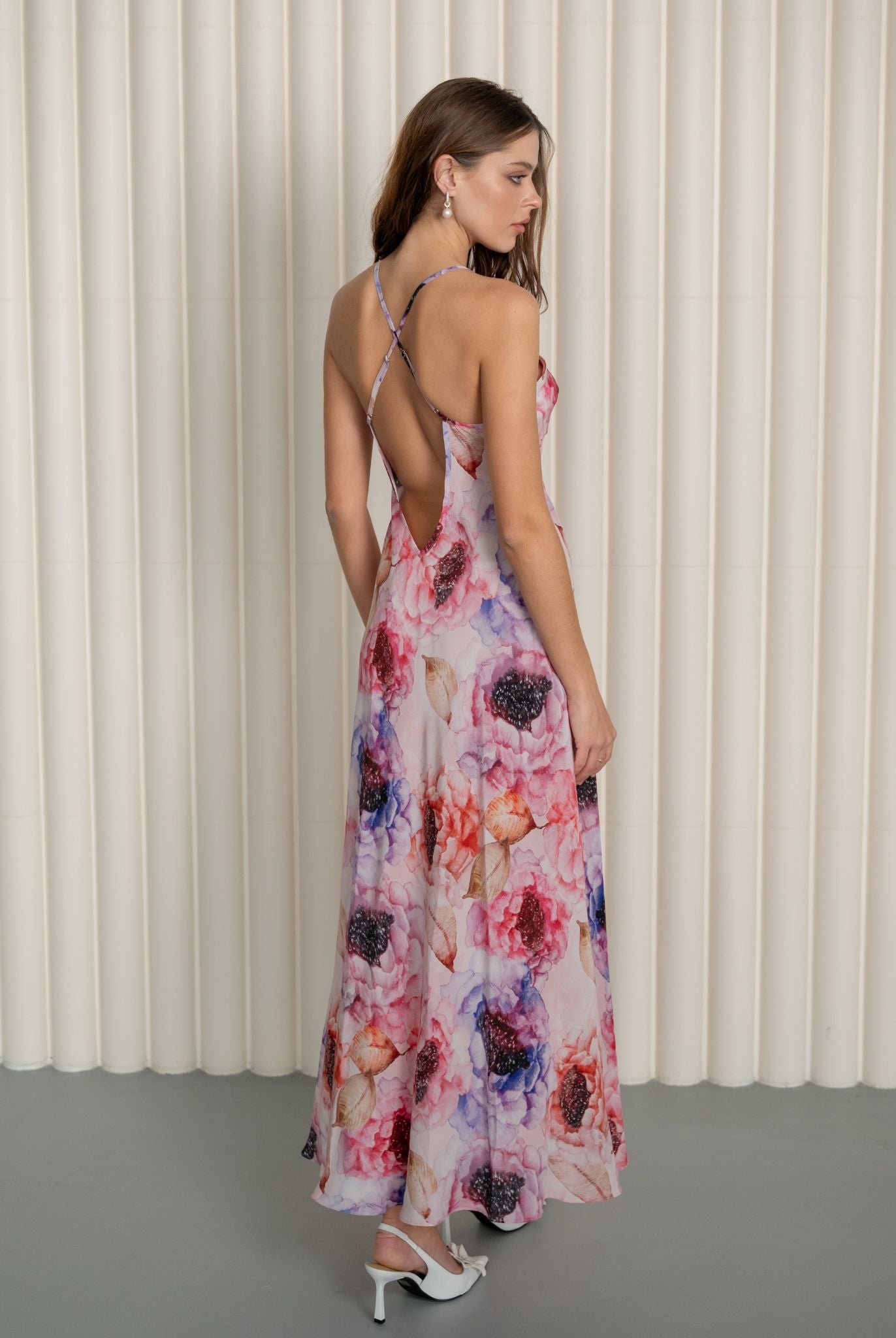 Rear view of a silk nightgown featuring crisscross back straps and a sophisticated mid-open V-cut design.