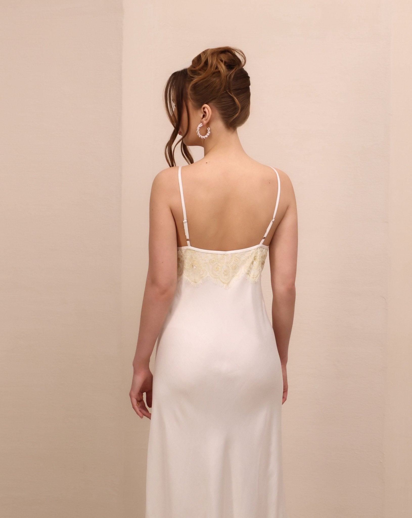 Rear view of the nightgown to the knees, illustrating the simple silhouette and the graceful fit of the garment.