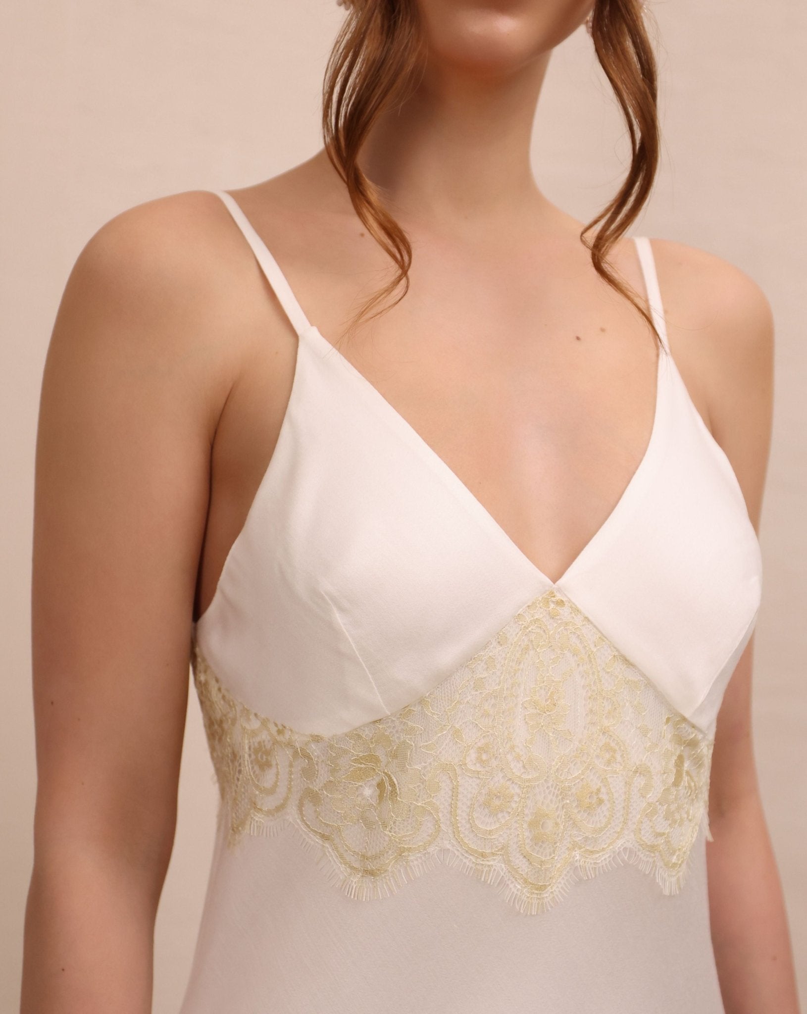 A close-up of the minimal slip dress, showcasing the clean neckline and the smooth, breathable texture on the skin.