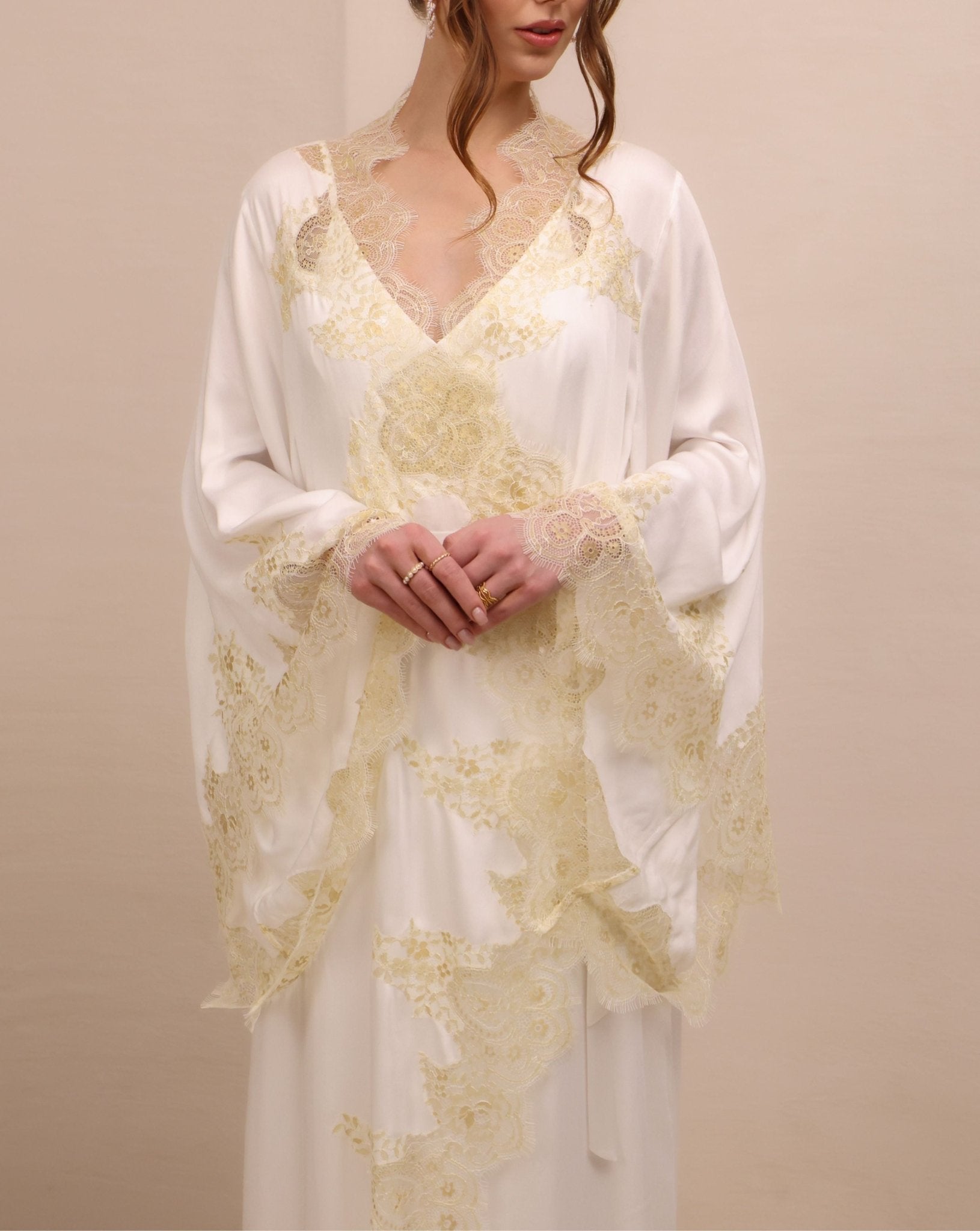 A mid-length shot focusing on the wide sleeves and the asymmetric lace placement that adds presence to the look.