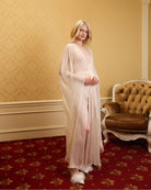 Elegant pose in a floor-length sheer wrap, capturing a moment of quiet elegance and sophisticated bridal style.