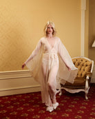 Full-length view of a flowing silk garment in motion, showcasing the fluid movement and refined bridal silhouette.