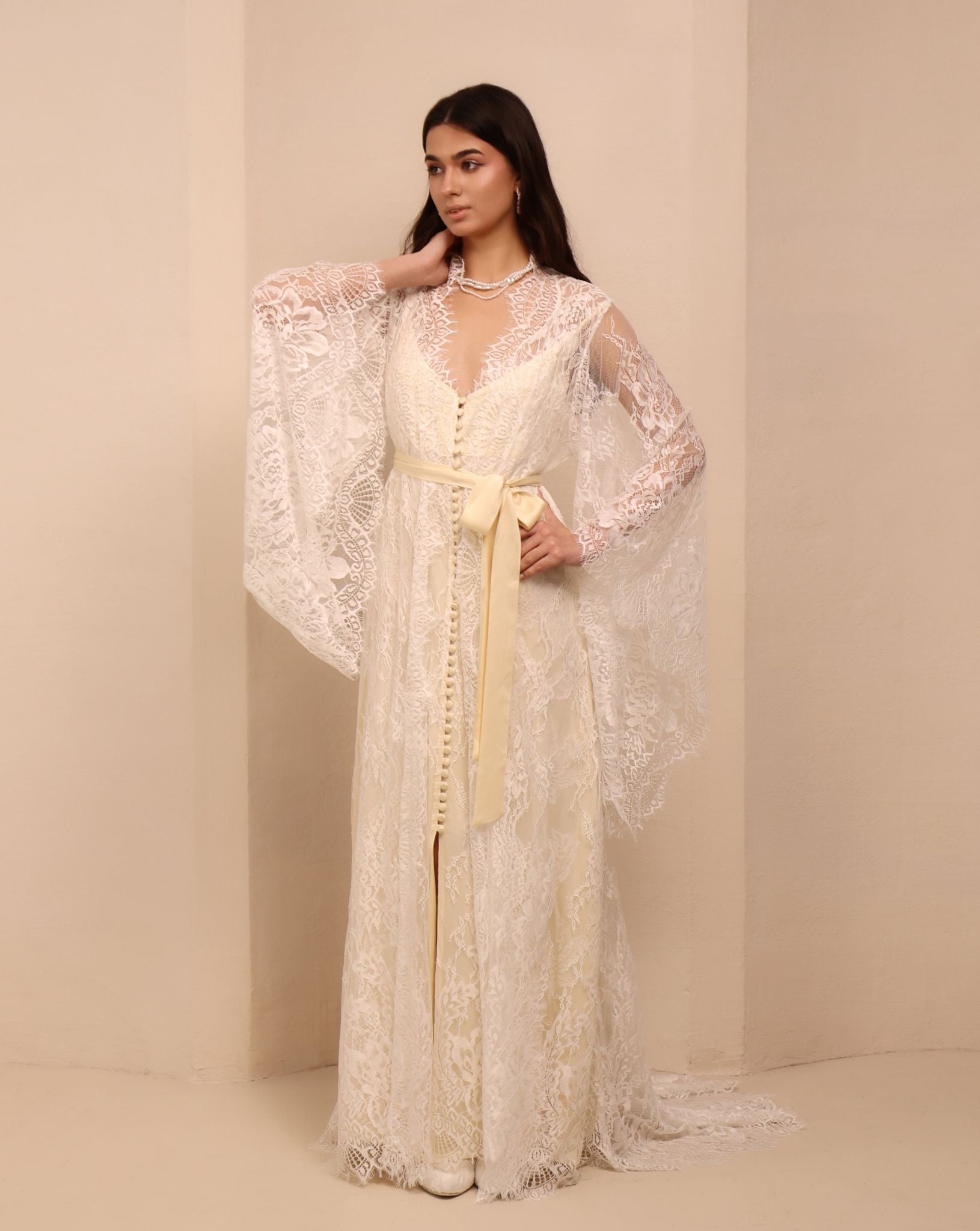 A side perspective of the attire, highlighting the graceful silhouette and the soft flow of the fabric.