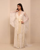 A side perspective of the attire, highlighting the graceful silhouette and the soft flow of the fabric.