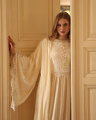 A mid-length shot in the doorway, highlighting the beautiful wide sleeves and the soft French lace detailing.