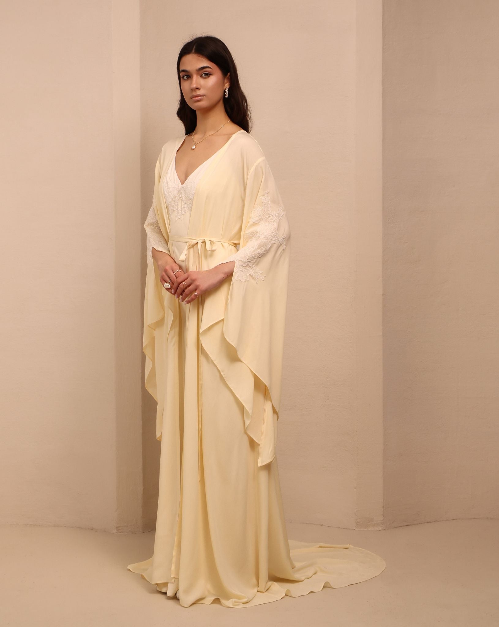 Side perspective of the tied ensemble, showcasing the sleeve slits and the sophisticated drama of the design.