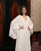 Mid-length view of the kimono style wrap, embellished with cotton lace for a touch of effortless grandeur.