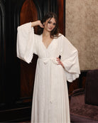 Mid-length view of the kimono style wrap, embellished with cotton lace for a touch of effortless grandeur.
