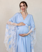 Mid-length frontal view with hands cradling the bump, highlighting the comfortable fit and hidden nursing zipper.