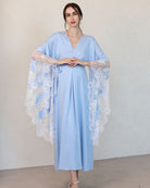 A full-length Maternity Kaftan with hands on the belly, showcasing the loose silhouette and lace-finished sleeves.