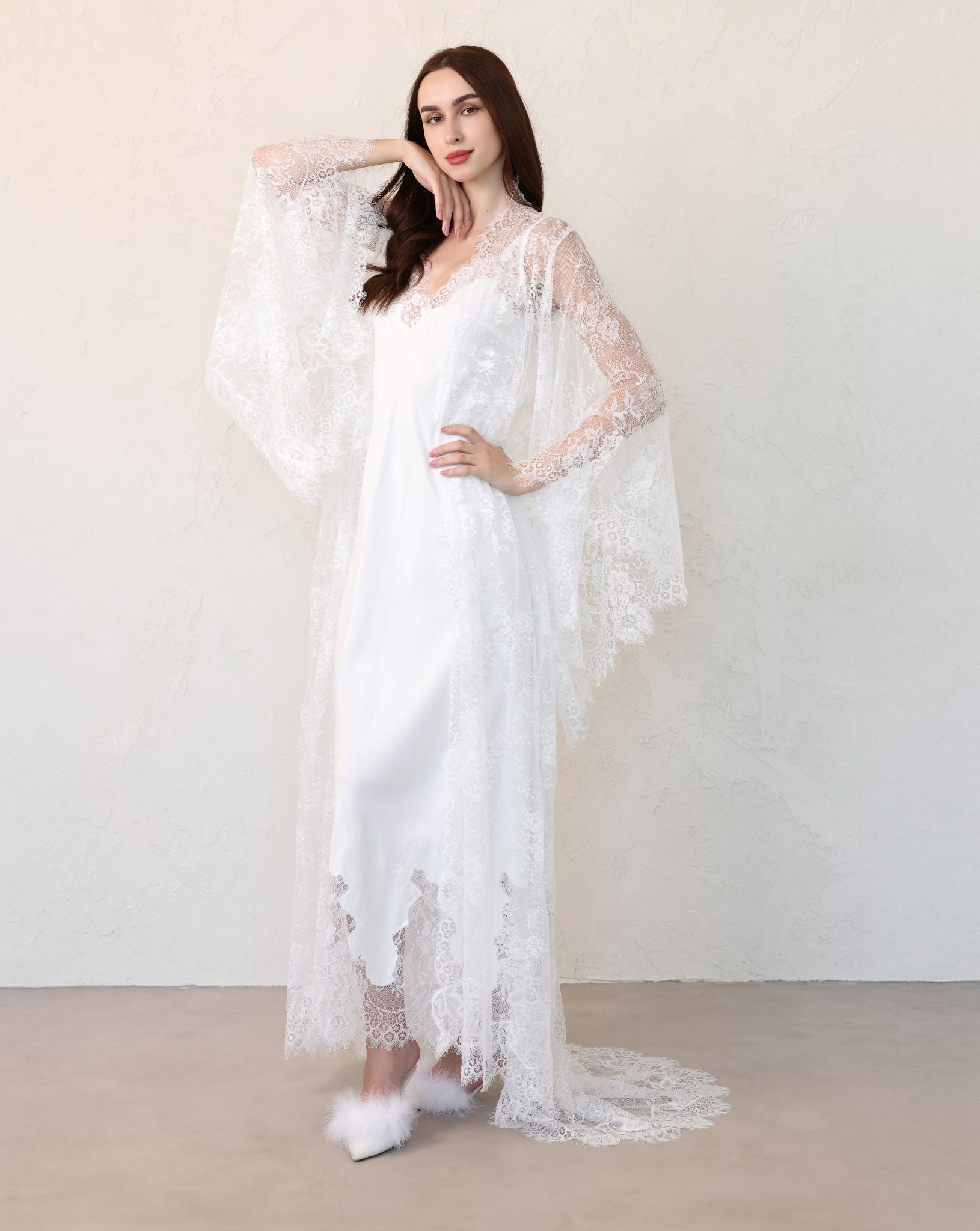 Bride adjusting lace robe sash, side view