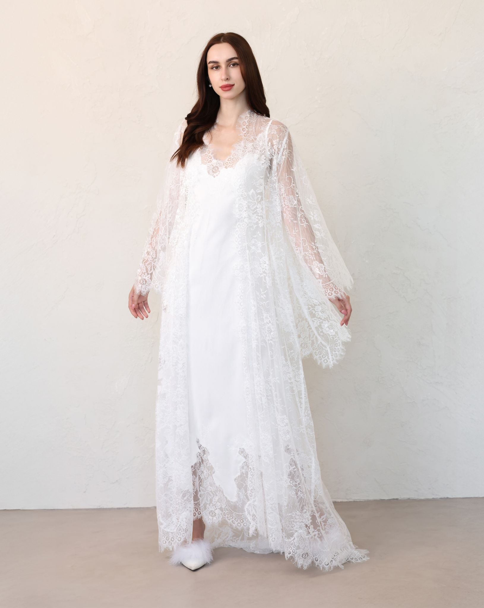 Bride walking forward in full-length lace robe over cotton dress