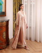 A side-view motion shot of the long robe, wrapping the body in softness that breathes and flows effortlessly.